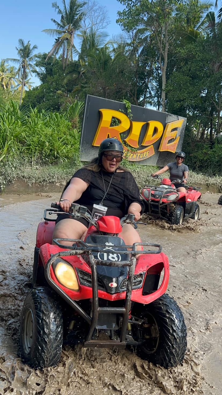 Customer riding a red ATV quad bike